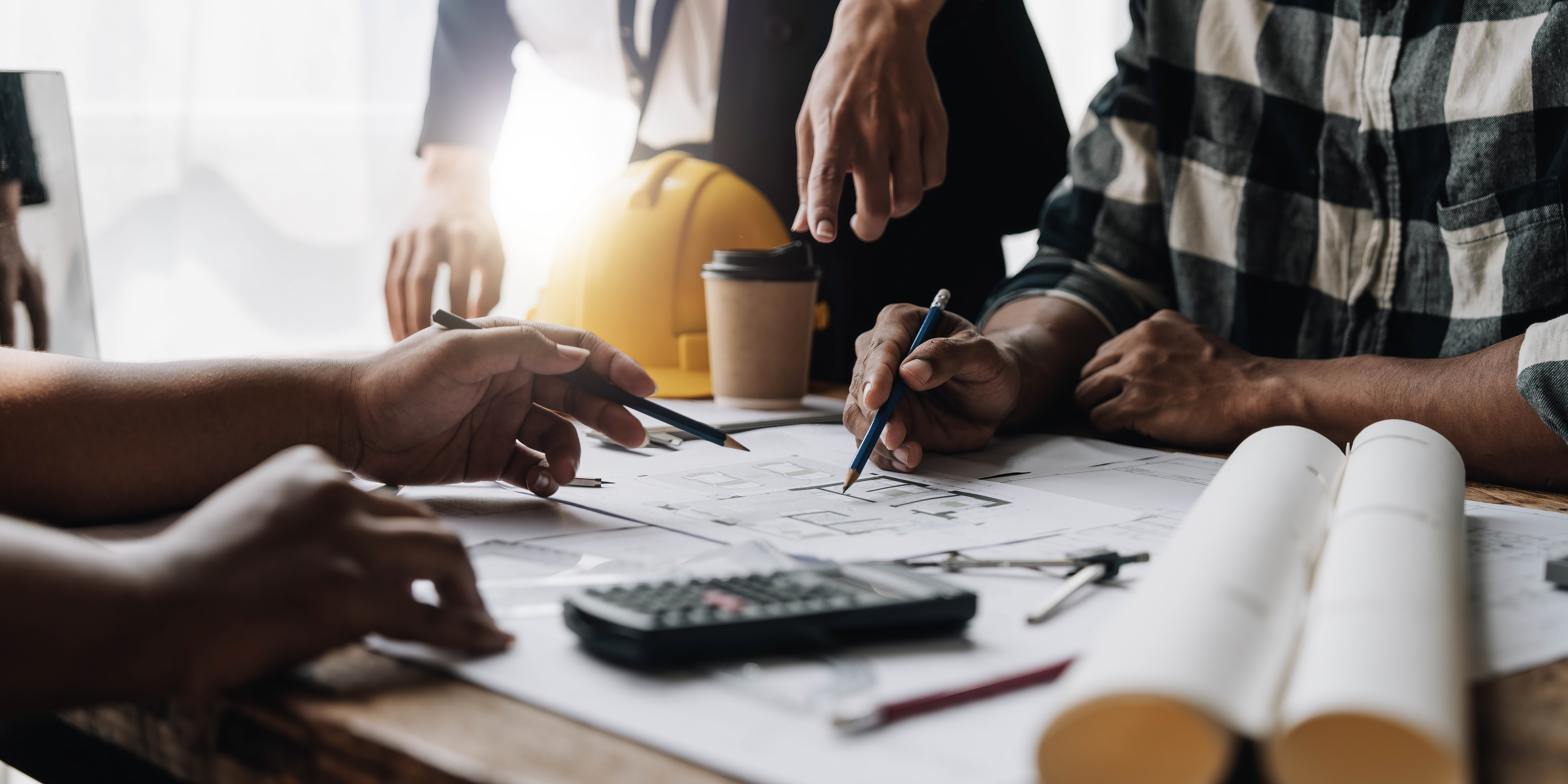 Réunion d'architectes autour de plans de construction